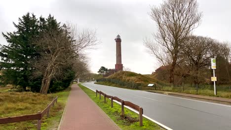 wide shot of famous german lighthouse on norderney island during cloudy day in autumn,germany