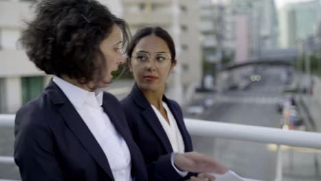 professional businesswomen discussing papers