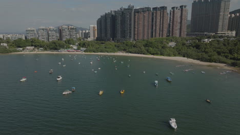 aerial drone shot of tourism boat on the water in the city in hong kong, china