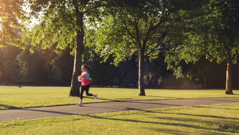 Road-runner-woman-running-in-park-in-the-morning-motion-track-high-definition-video