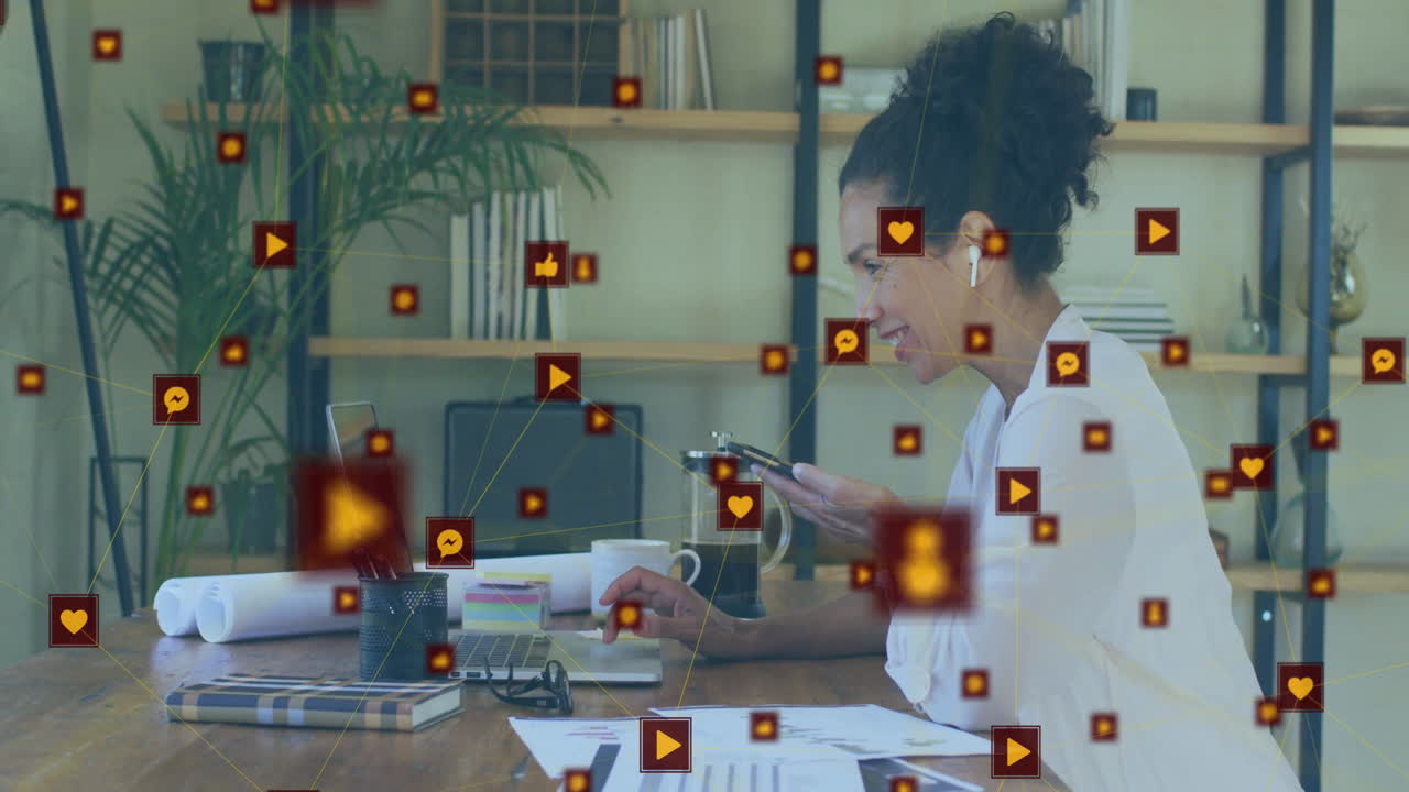 At desk, woman surrounded by animation of social media icons, smiling