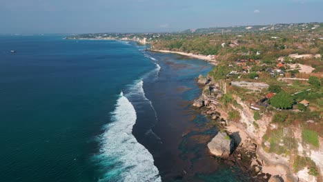 aerial view capturing landscape of uluwatu beach in bali, indonesia during daytime.