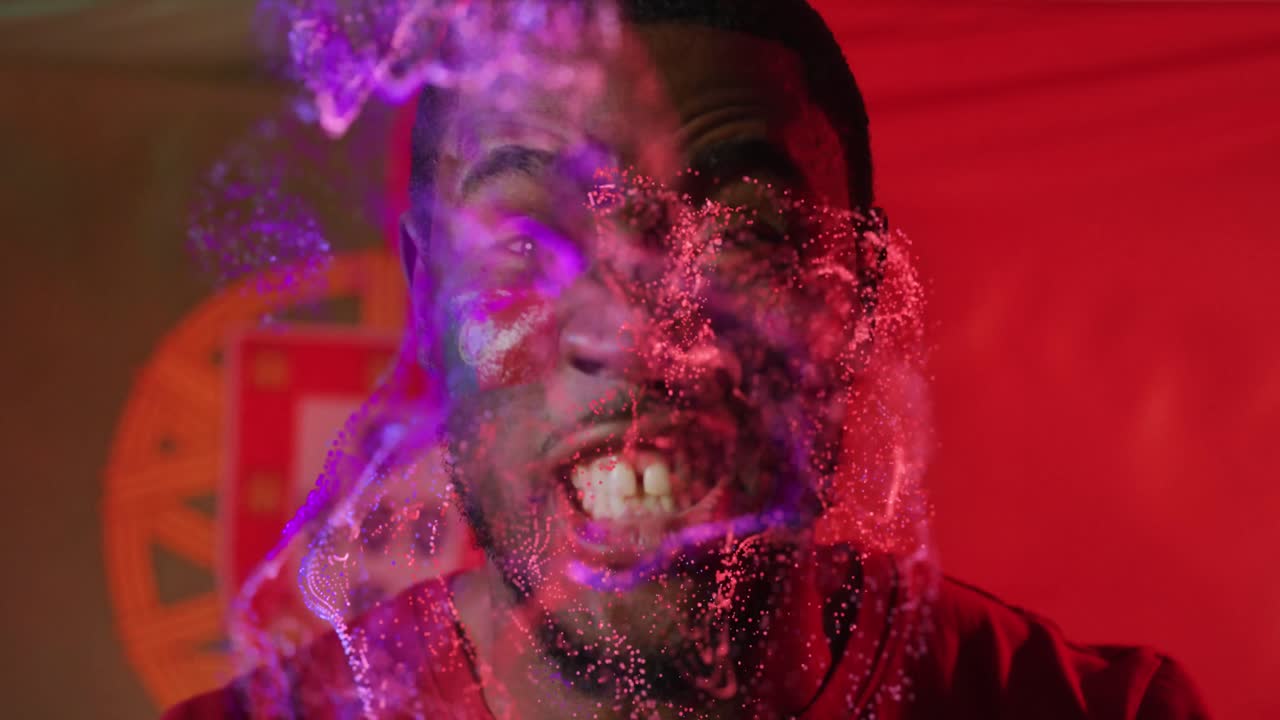 Animation of african american male supporter with flag of portugal over shapes