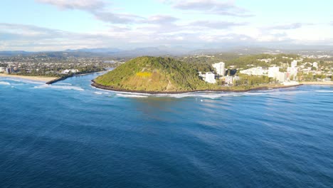 tallebudgera beach and creek next to forested burleigh headland in gold coast, australia