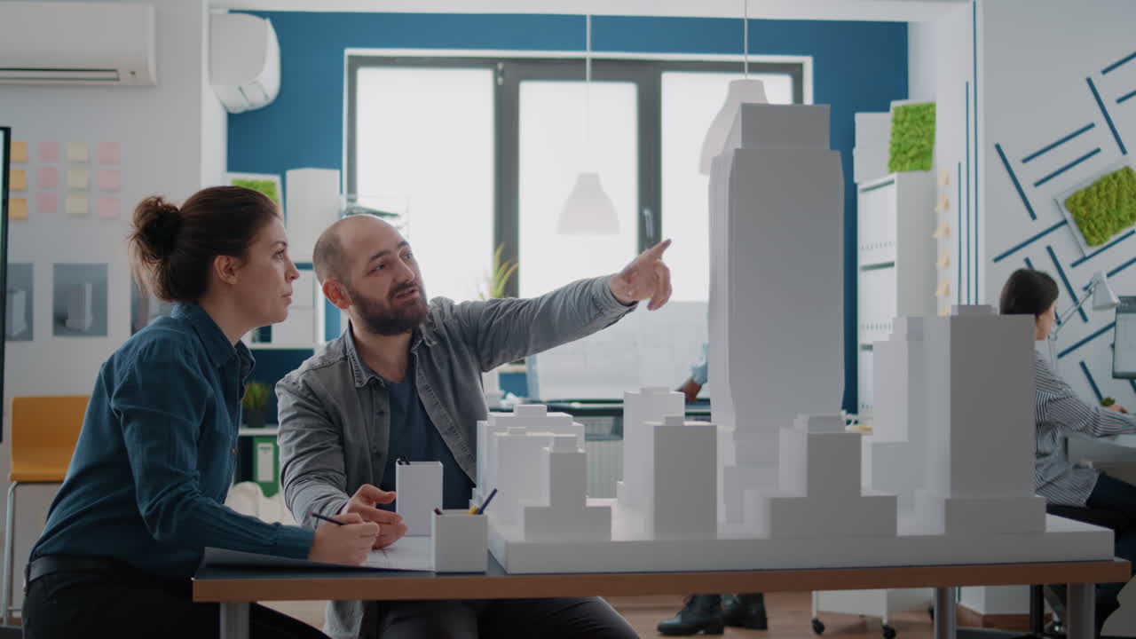 Architects collaborating on a building model in the office