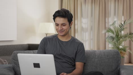 Happy-Indian-man-working-on-laptop