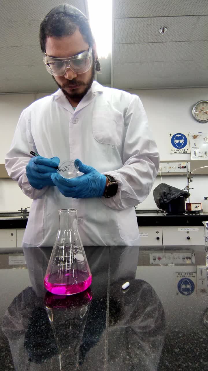 Scientist Labeling Petri Dish in Laboratory