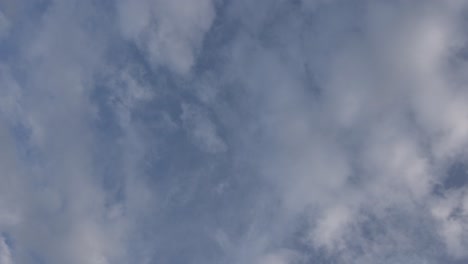 fluffy clouds against a blue sky at sunset, time lapse