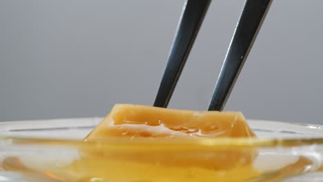 honeycomb candy dipping in honey