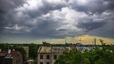 dark stormy clouds overcoming sunshine over small town, time lapse view