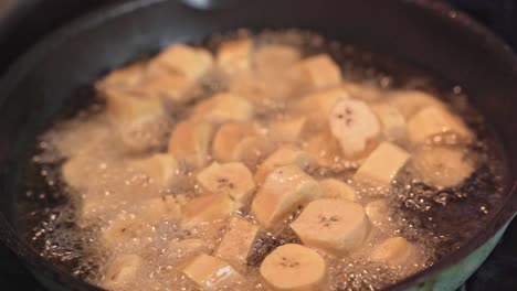 close-up of banana slices fried in boiling oil