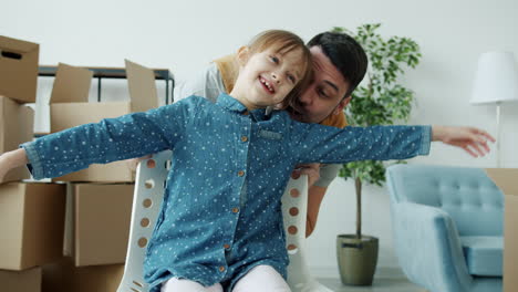 father and daughter playing in new home