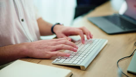 person typing on a keyboard at a desk