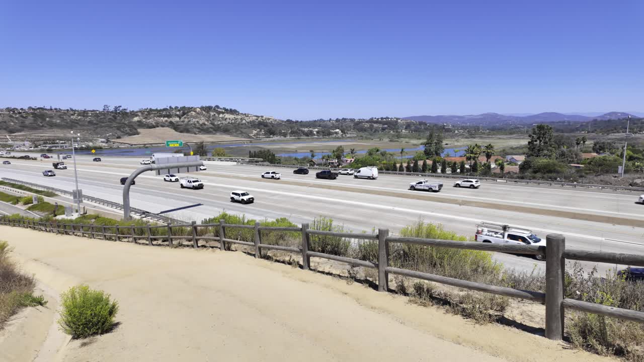 Annie’s Canyon Trail overlooking Interstate 5 in Solana Beach. Blends nature and infrastructure, showing moving traffic beside preserved wetlands and hiking trails along California’s coastal corridor