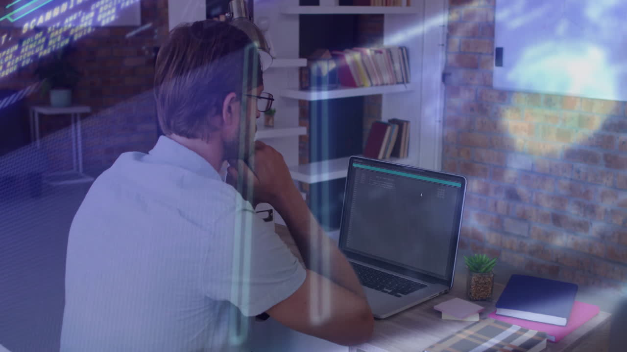 Man working on laptop with digital data processing animation overlay