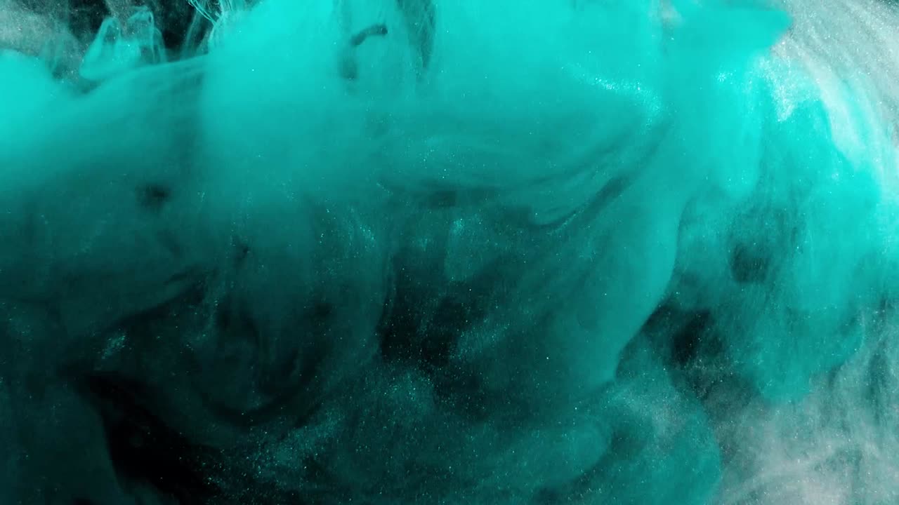 Abstract forms. Shooting on a black background. Mixing of paints