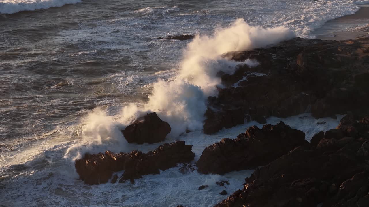 Aerial view of the waves hitting the rocks off the coast of Portugal in slow motion 3