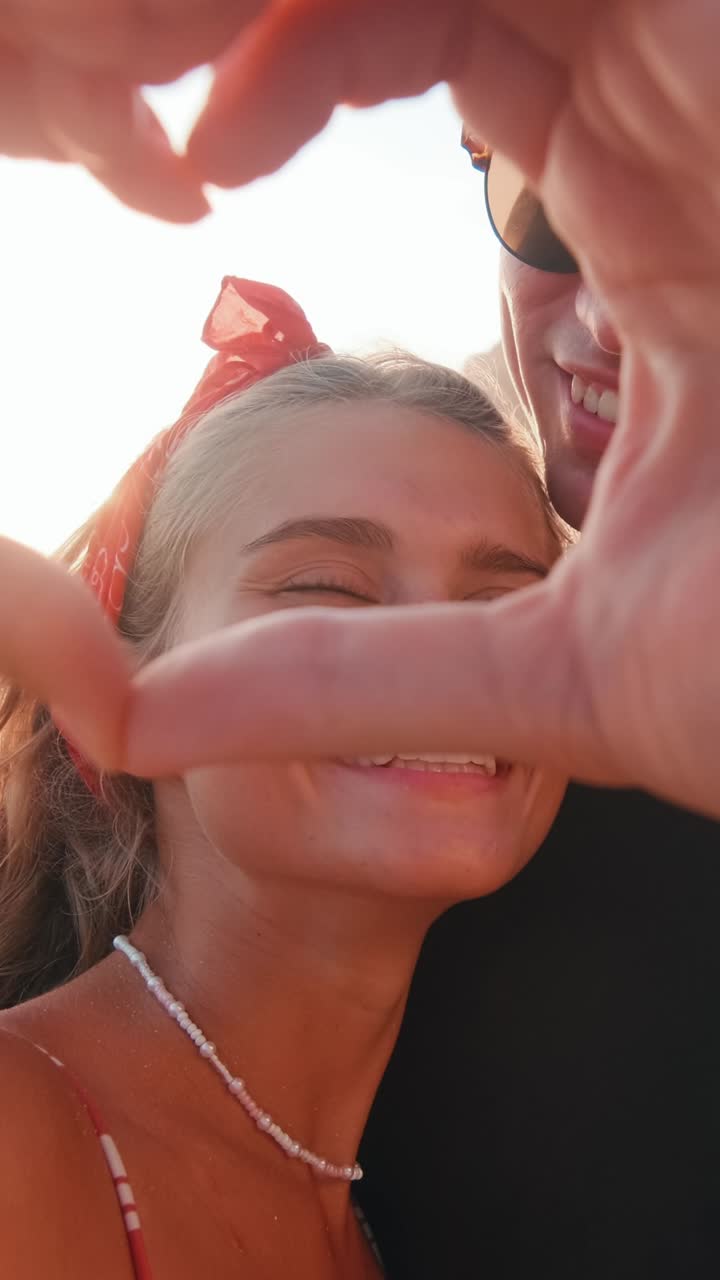 Young romantic caucasian couple of man and woman kissing stand on sea beach
