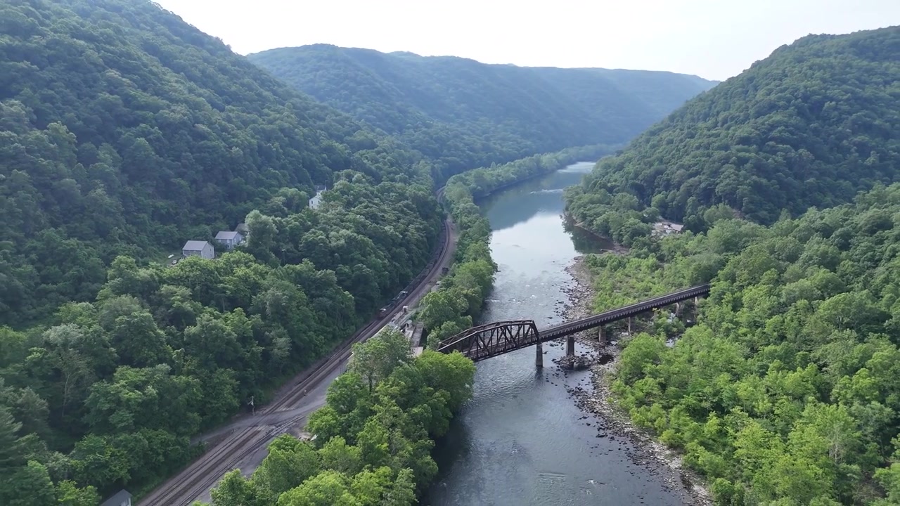 drone flight over the winding river at New River Gorge National Park, West Virginia. Aerial Above historical iron bridge travel destination