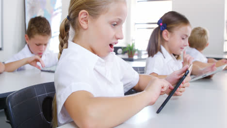 School-kids-using-digital-tablet-in-classroom