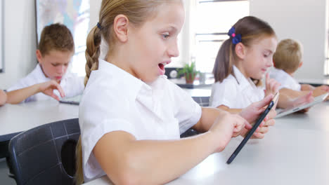 School kids using digital tablet in classroom