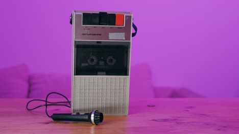 vintage cassette player and microphone on a wooden table