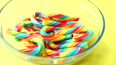 mini cherry candy canes on yellow background