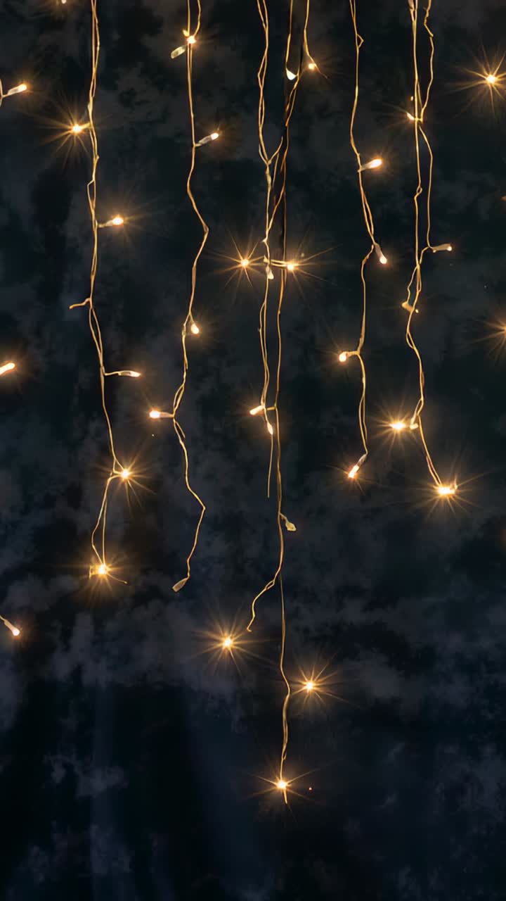Vertical video: Opening shot showing warm white LED string lights pulsing as backdrop on dark wall