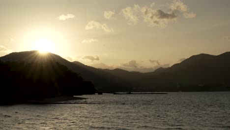 Tranquilo-Atardecer-De-Hora-Dorada-Con-Destellos-Solares-Detrás-De-Las-Montañas-Con-Vistas-A-La-Bahía-De-Hiroshima.