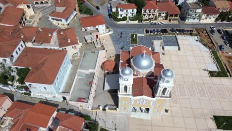 aerial establishing shot, metropolitan cathedral ypapanti church, revealing cityscape and taygetos mountain foot, push out, tilt up 4k
