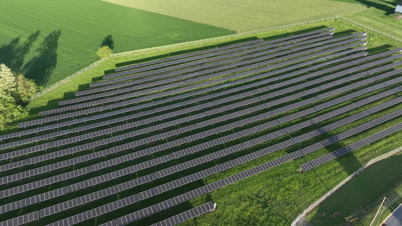 Large Solar Panels Photovoltaic Farm in american rural suburb. Aerial top down shot. Sunny day in spring season. Modern field installed with solar panel units.