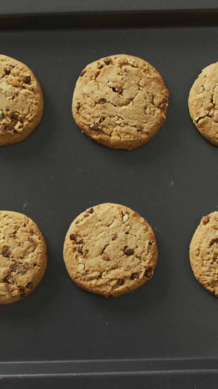 Video of biscuits with chocolate on baking tray over white background
