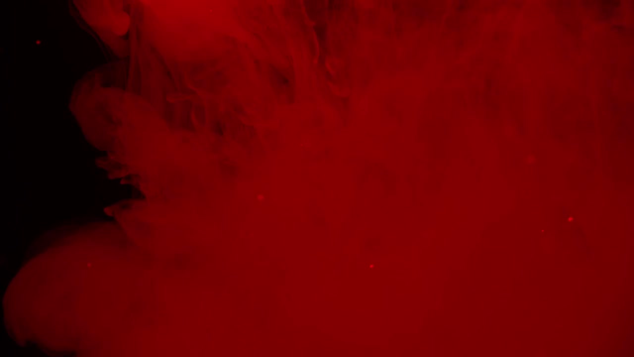 Vortici e particelle di fumo rosso astratto.