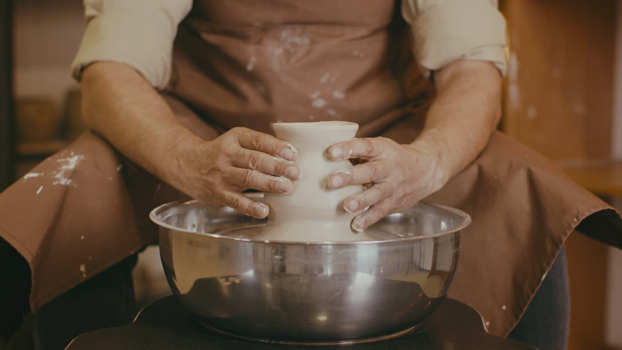 Pottery Artist Shaping Clay on Pottery Wheel