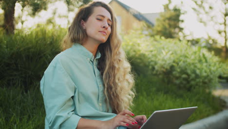 Portrait-of-Happy-Female-Freelancer-Working-on-Laptop-on-Street