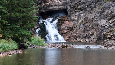 close up of a beautiful waterfall in glacier national park, running eagle falls named after a female warrior native american