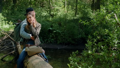 couple hiking in forest by a river