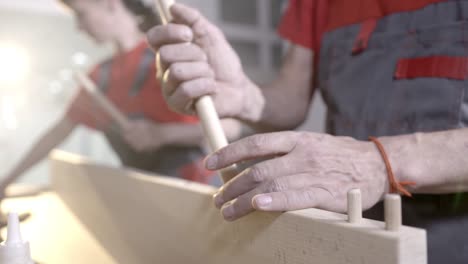 two people working on a wooden project