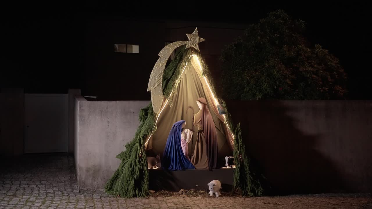 beautifully decorated outdoor nativity scene with Mary, Joseph, and baby Jesus under a glowing golden star