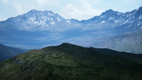 Mountain-gorge-with-green-meadow-illuminated-by-the-sun