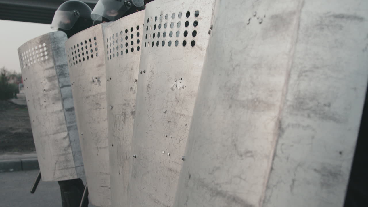 Riot Police Line with Shields and Helmets