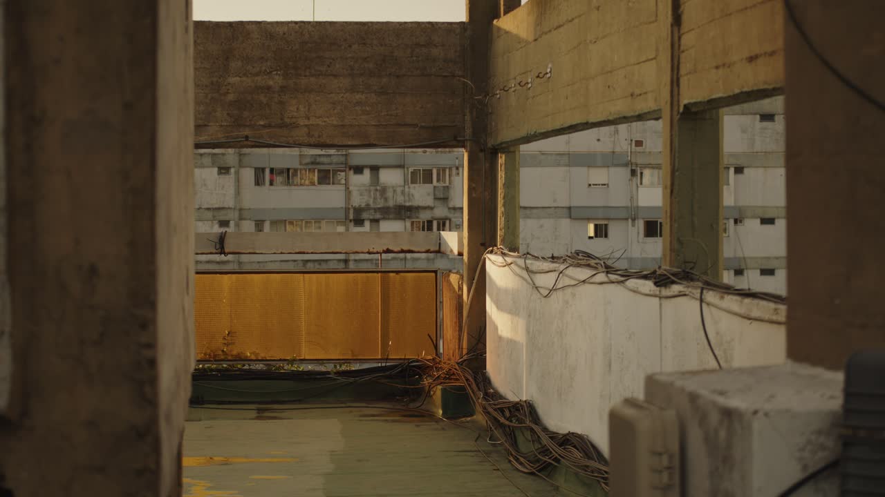 Golden sunlight illuminates an abandoned building corridor with urban decay in Buenos Aires