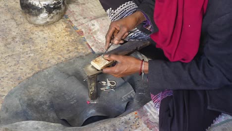 slow shot of a tuareg cutting wood