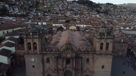 sweeping aerial pullback from cusco cathedral, peru, cityscape and mountainous backdrop