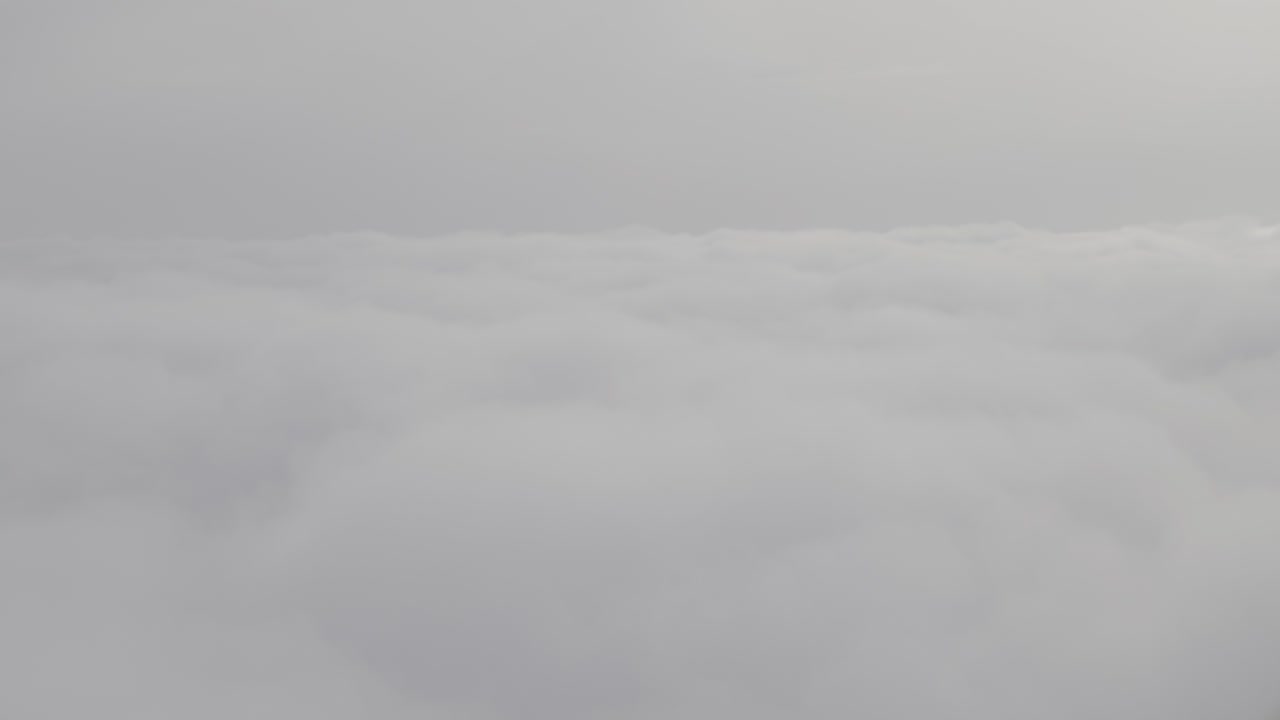 Cloudscape above the clouds, soft textures under a hazy, overcast sky