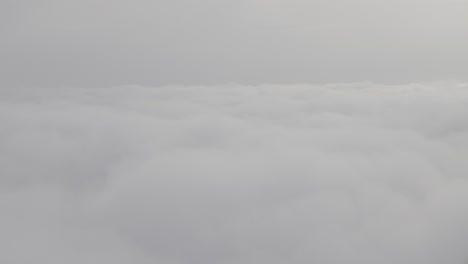 cloudscape above the clouds, soft textures under a hazy, overcast sky