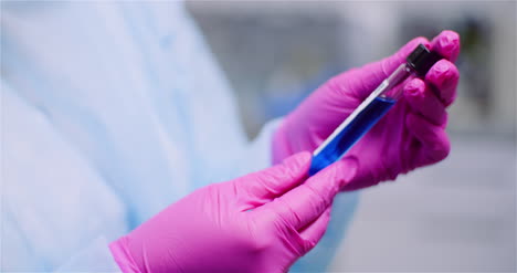 working in lab scientist holding test tubes positive test of covid 19 coronavirus at laboratory 4