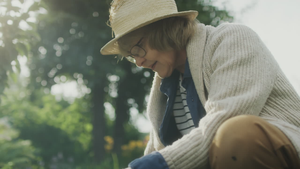 Senior woman gardening in a sunlit garden
