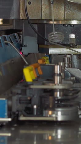 automatic hole making machine operates with plastic material sheet in plant workshop closeup. contemporary technology of manufacture. factory equipment