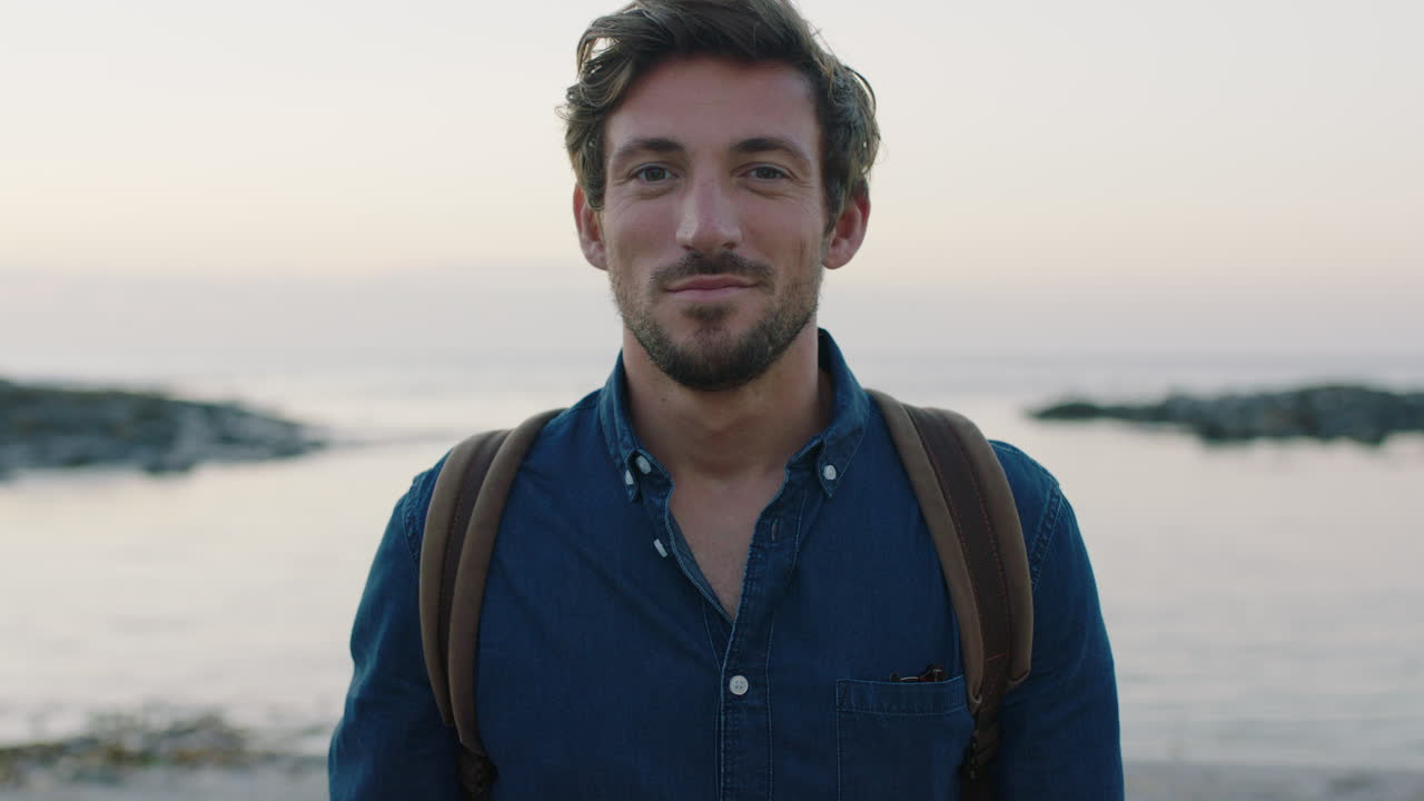 portrait of attractive charming caucasian man smiling confident on calm seaside beach